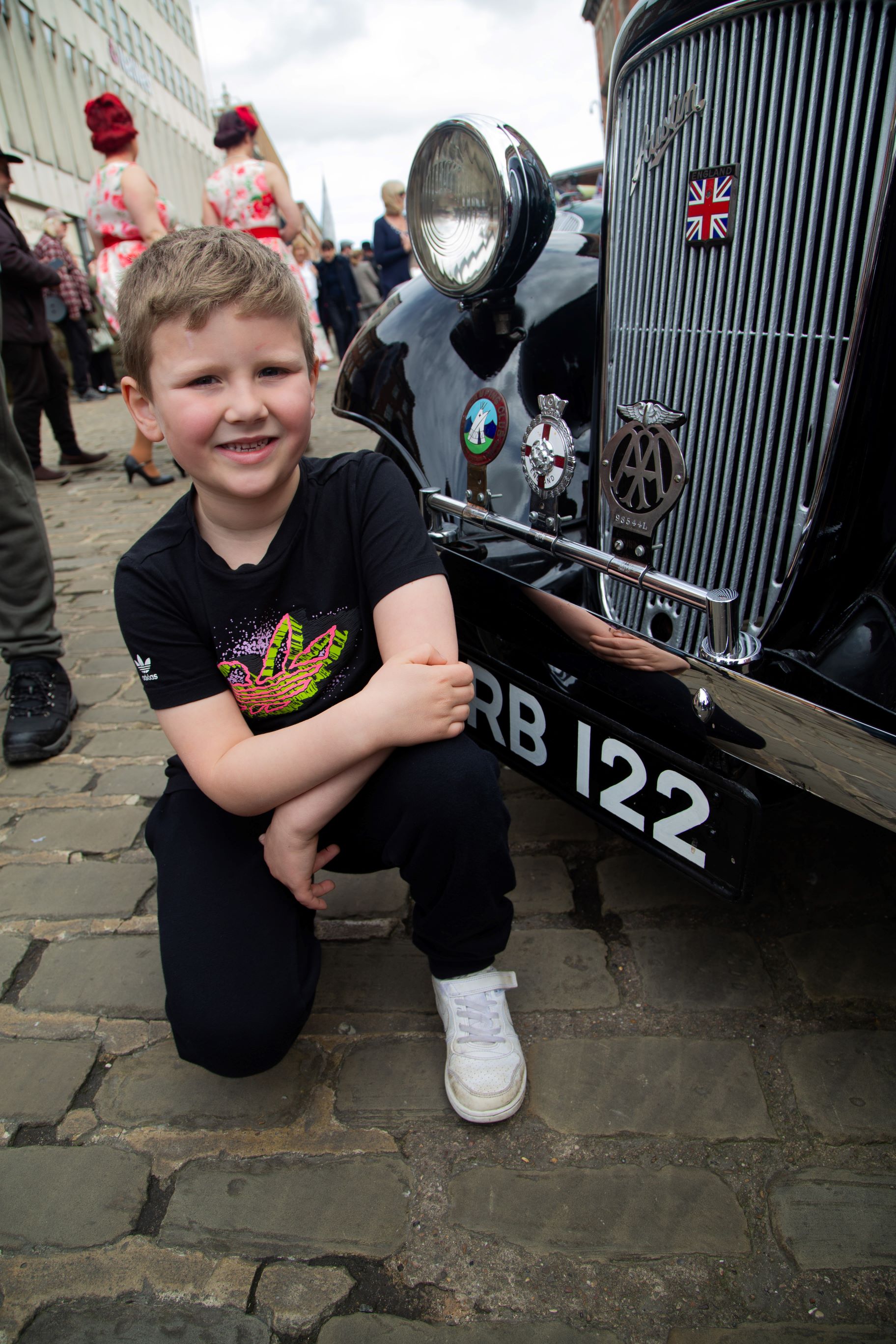 Young boy with a classic car at last year's event 