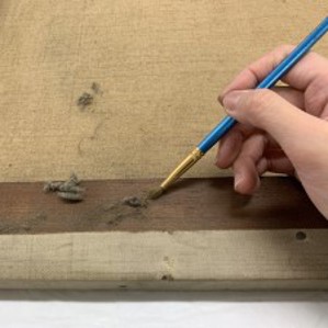 Removal of dirt with a paintbrush