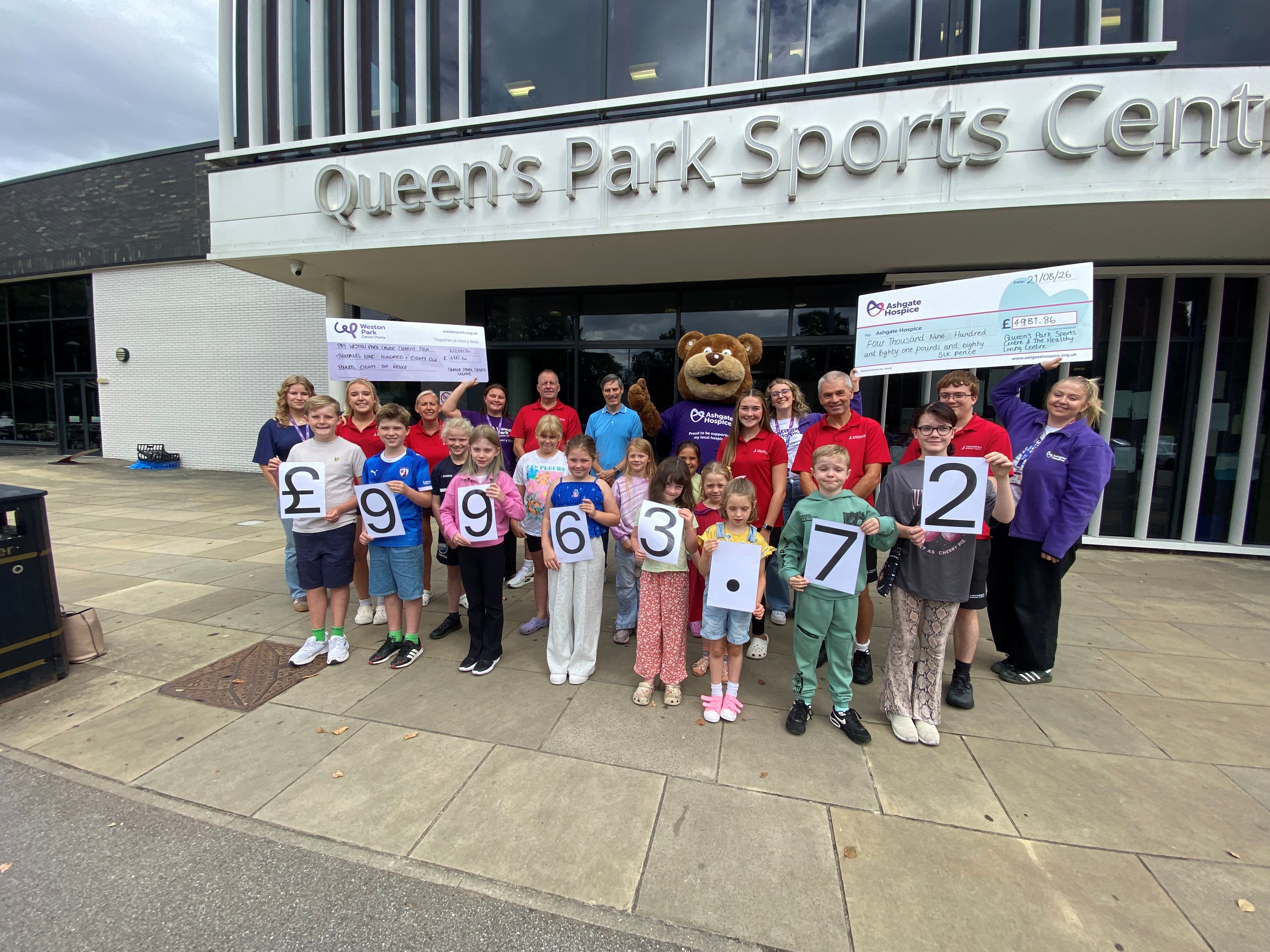 Councillor Gavin Baldauf-Good, Chesterfield Borough Council’s cabinet member for customers and business transformation, with representatives from both charities and some of the children who took part in the sponsored swim.