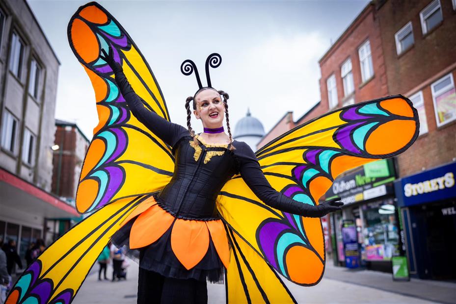 Butterfly Stilt walker spreading their wings
